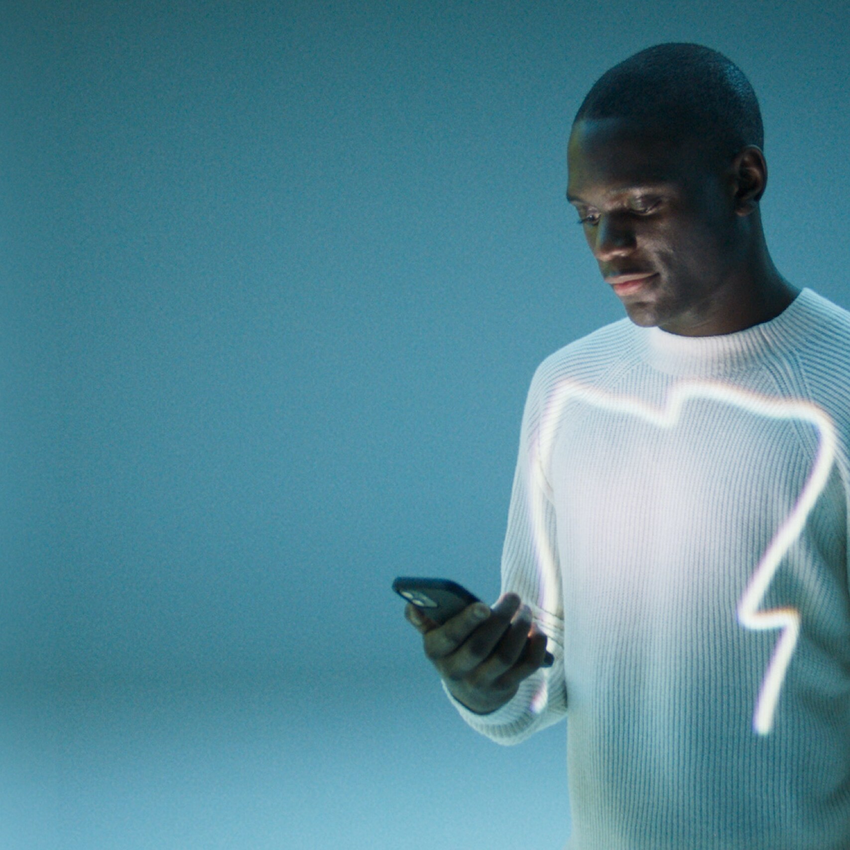 Een man opent de Mercedes-Benz App op zijn smartphone.