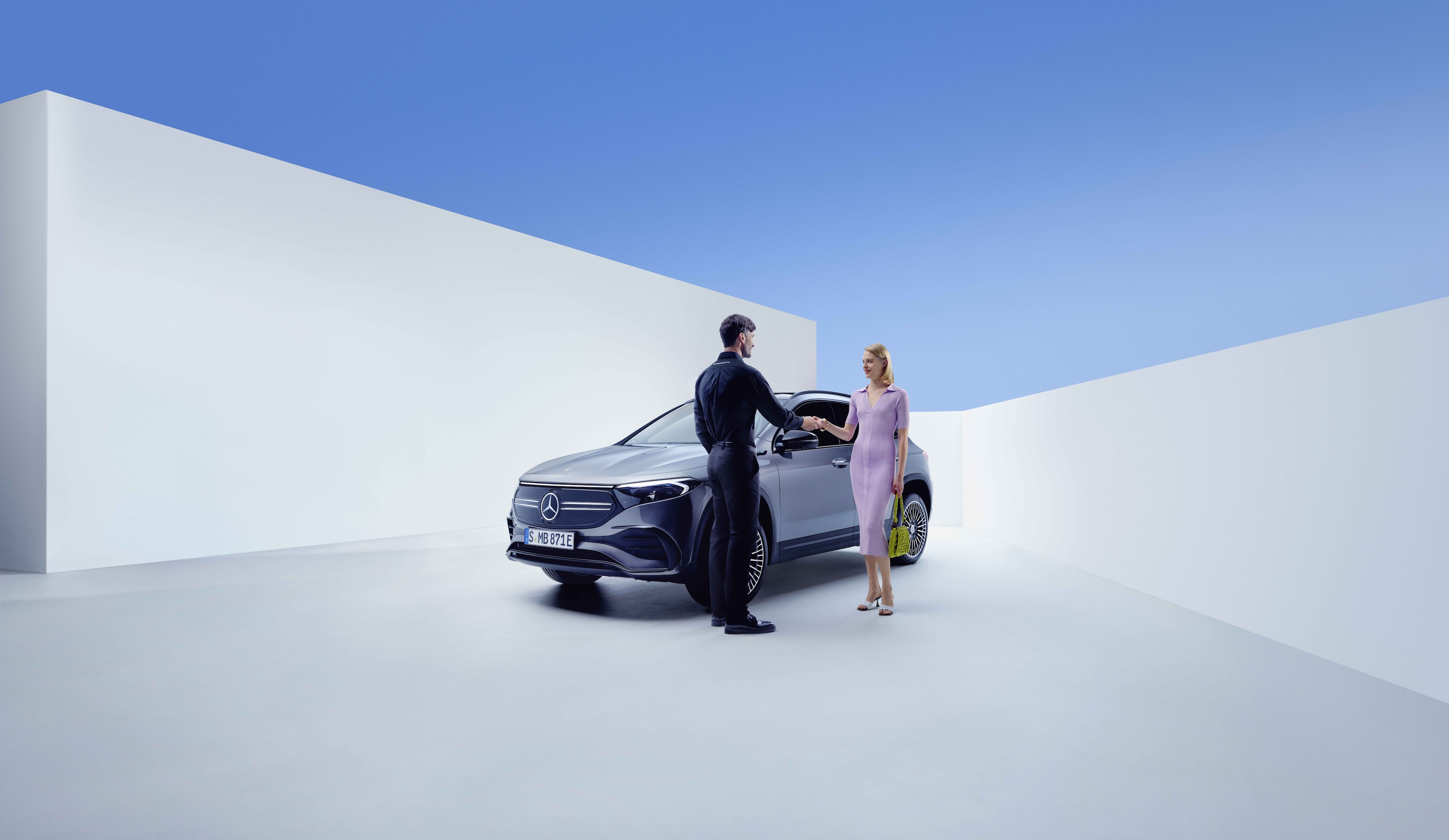 Service en reparatie | Mercedes-Benz Een Mercedes-Benz medewerker en een vrouw geven elkaar de hand vóór een Mercedes-Benz