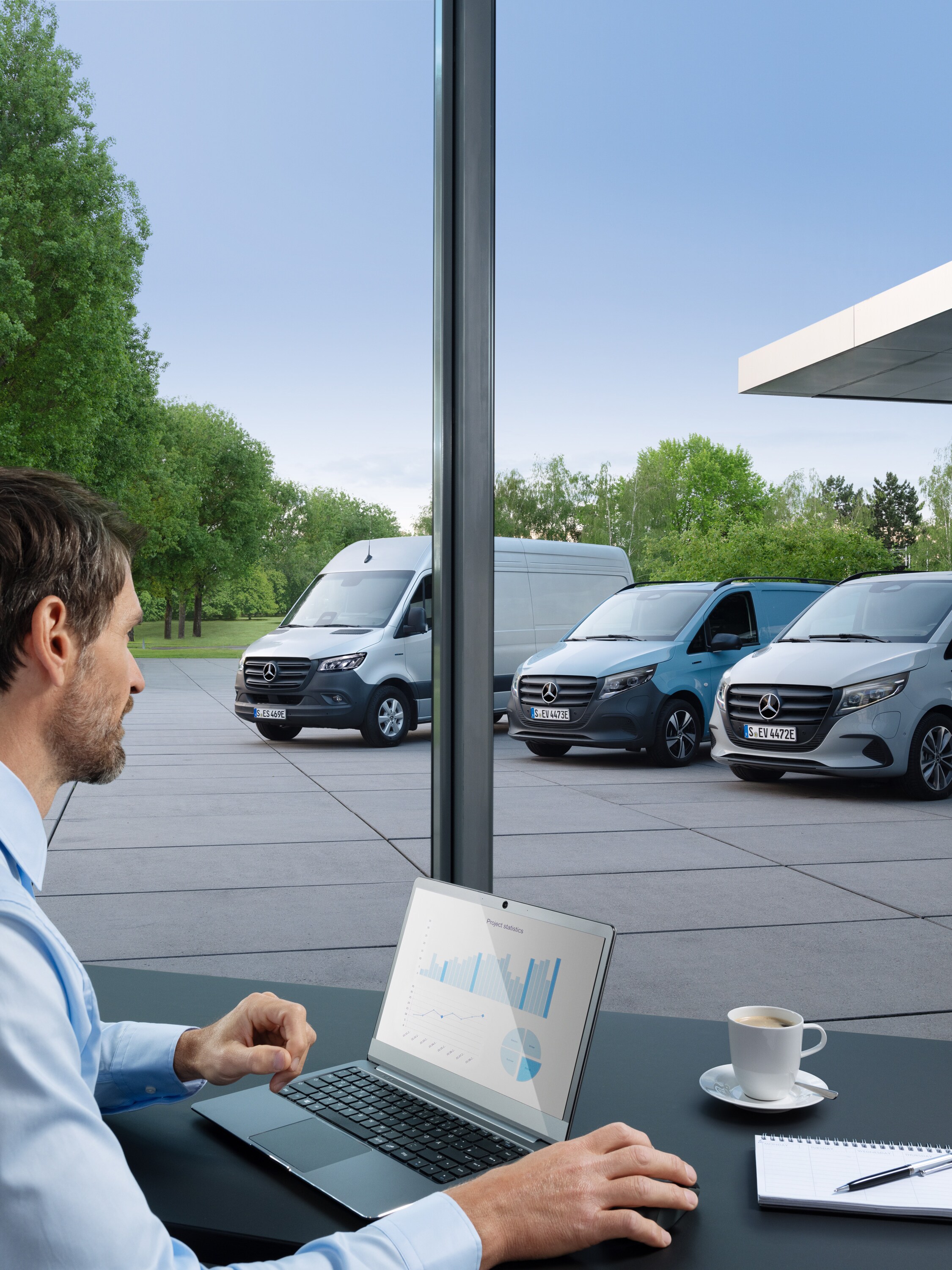 Man met laptop bewaakt meerdere geparkeerde Mercedes-Benz Bedrijfswagens als symbool voor digitaal vlootbeheer.
